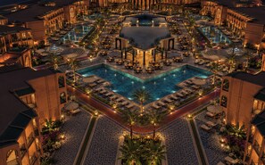 A large hotel with multiple swimming pools, outdoor seating areas, and a central courtyard. - Palmeraie Golf Palace by Pickalbatros (Marrakech)
