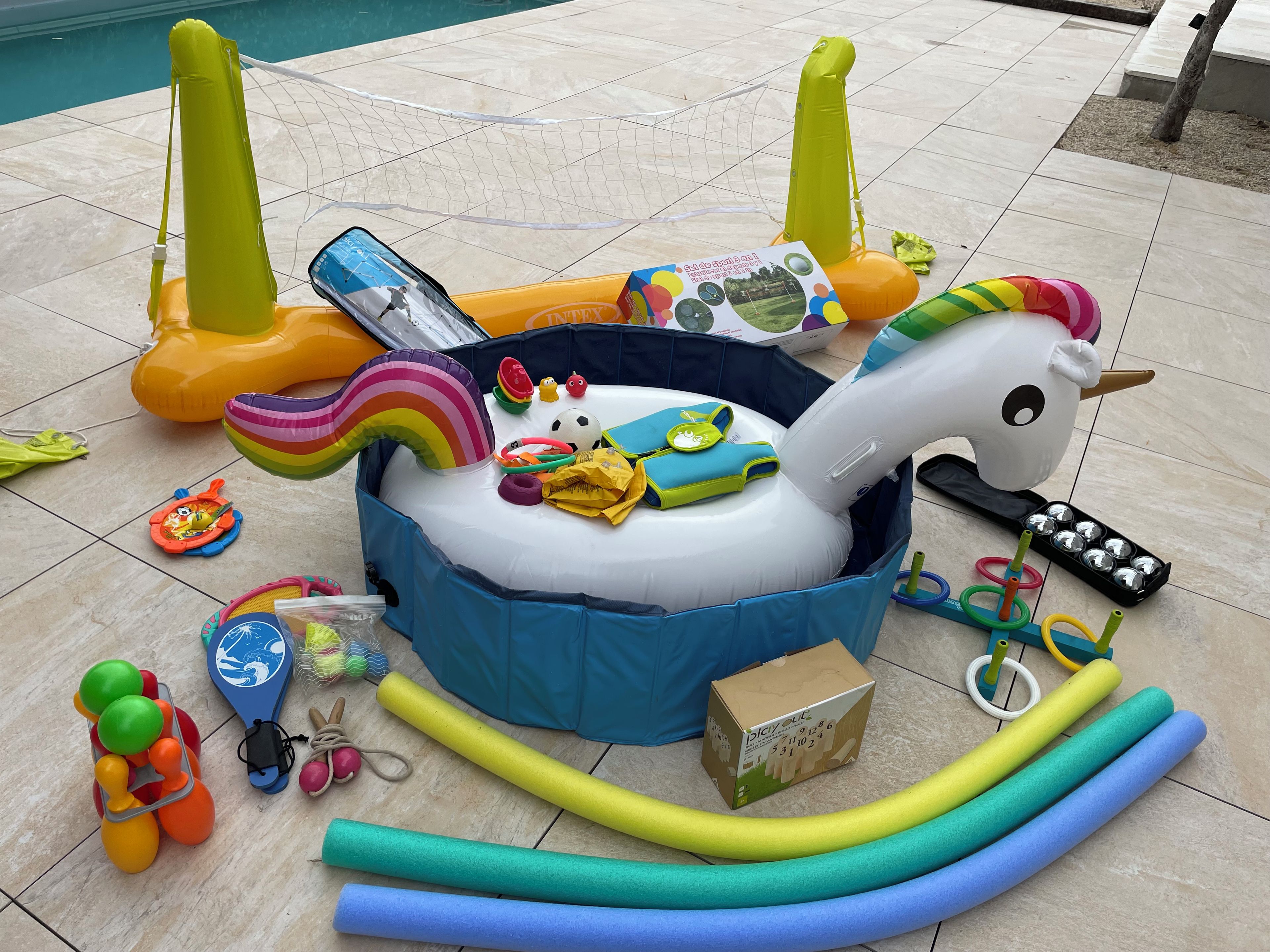 An inflatable pool with various toys and accessories.