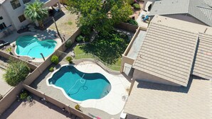 A residential area with two swimming pools, a covered patio, and a building with a tiled roof. - Spacious 6-BR Furnished 30 day rental! Great Pool! (Chandler)
