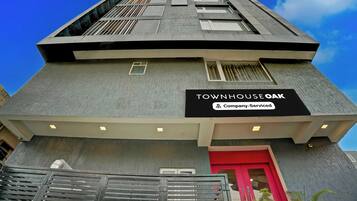 A building with a sign reading 'TOWNHOUSE OAK' and 'Company-Serviced'.