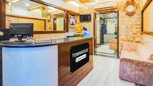 A reception desk with a 'Reception' sign, a 'Tom House' sign, and a 'No Outside Food Allowed' sign. - Townhouse Sindhi Camp (Jaipur)