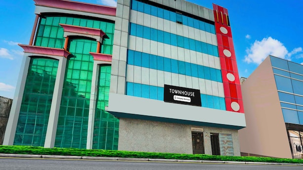 A modern building with a sign indicating it is a company-serviced townhouse. - Townhouse Sindhi Camp (Jaipur)