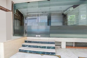 A modern interior with a glass door entrance, marble steps, and a clean, minimalist design. - Townhouse Bhopal DB City Mall (Bhopal)