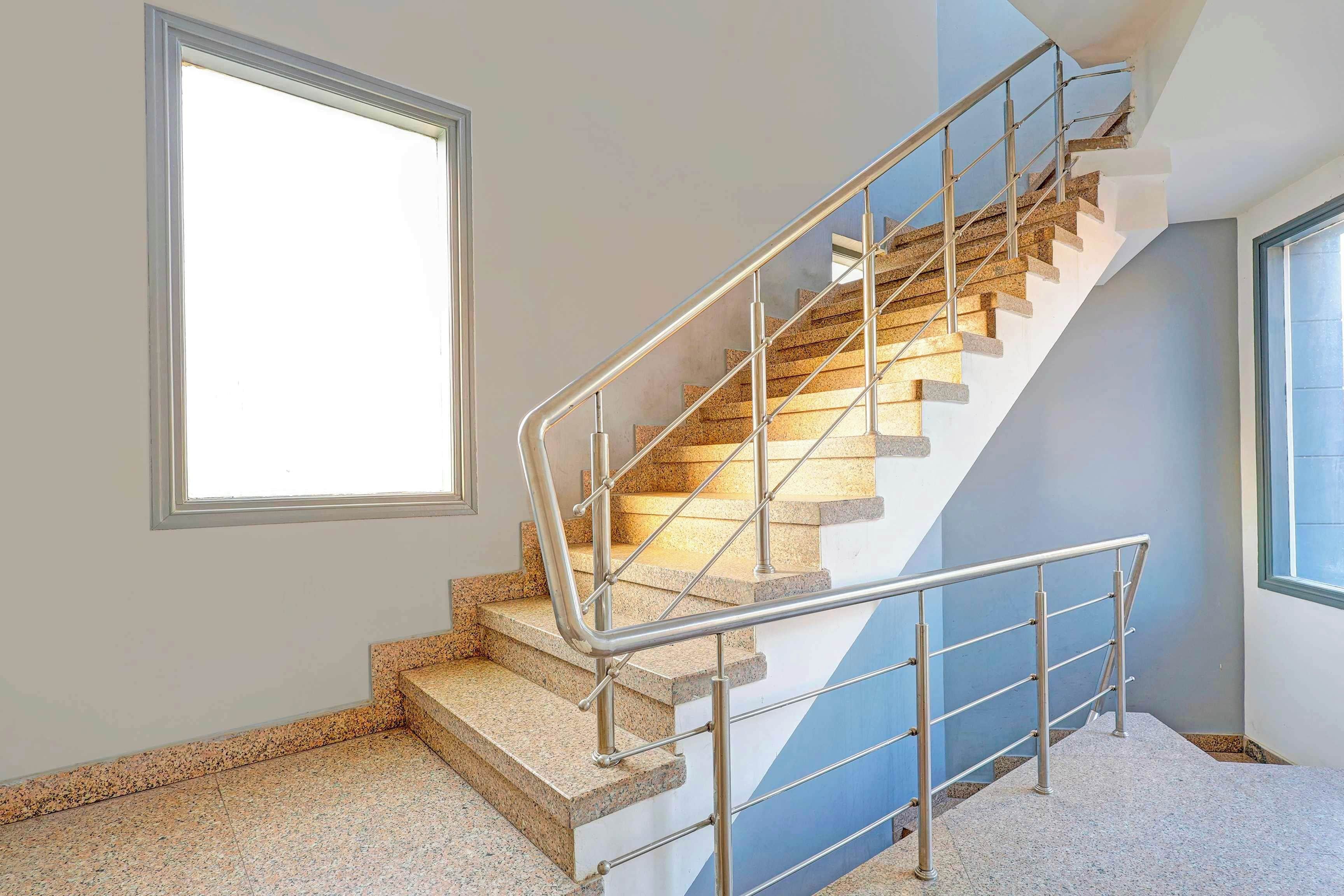 A staircase with metal railings and granite steps.