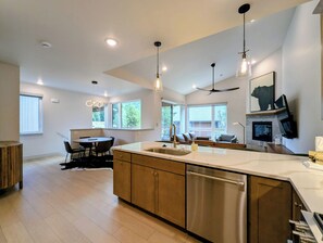 A modern kitchen with a central island, built-in appliances, and pendant lighting. - NEW BUILD! King Bed | Shuttle to Slopes (Keystone)