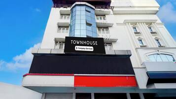 A multi-story building with a prominent sign reading 'TOWNHOUSE Company-Serviced'.