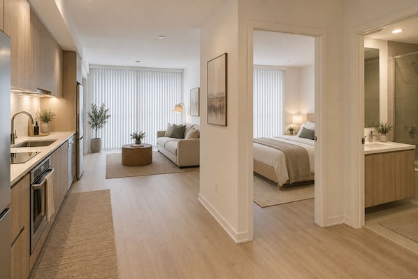 Un appartement moderne comprenant une cuisine, un espace de vie et une chambre.