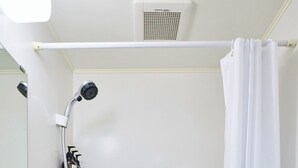 A bathroom with a white sink, a handheld showerhead, and a bathtub. - Vrbo Property (板橋区)