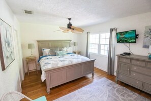 A bedroom with a bed, a ceiling fan, a television, and a dresser. - Private 3BR Pool Home | Pet Friendly | Sleeps 8 (Bradenton)