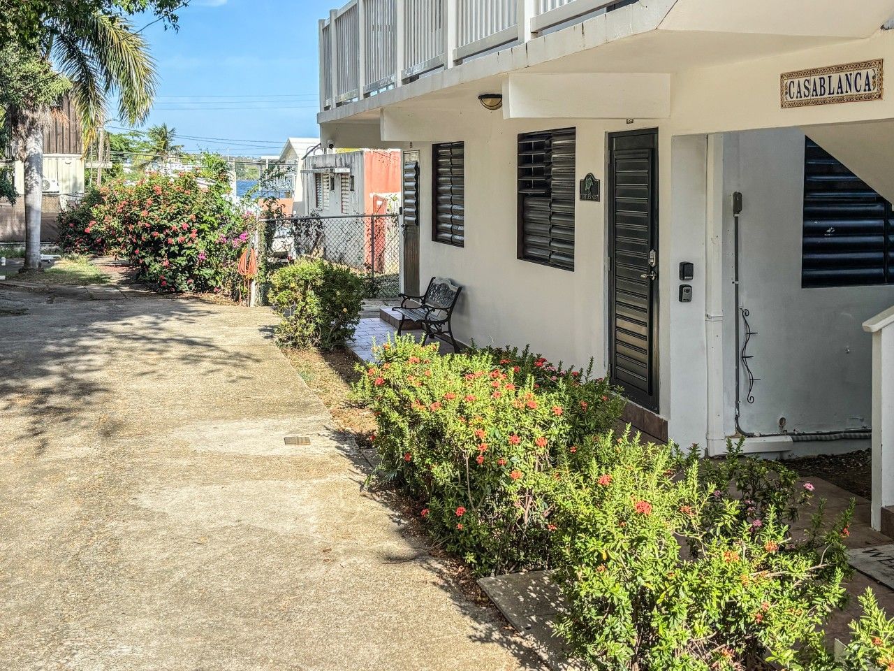 A residential building with a sign reading 'CASABLANCAS' and a paved pathway leading to the entrance.