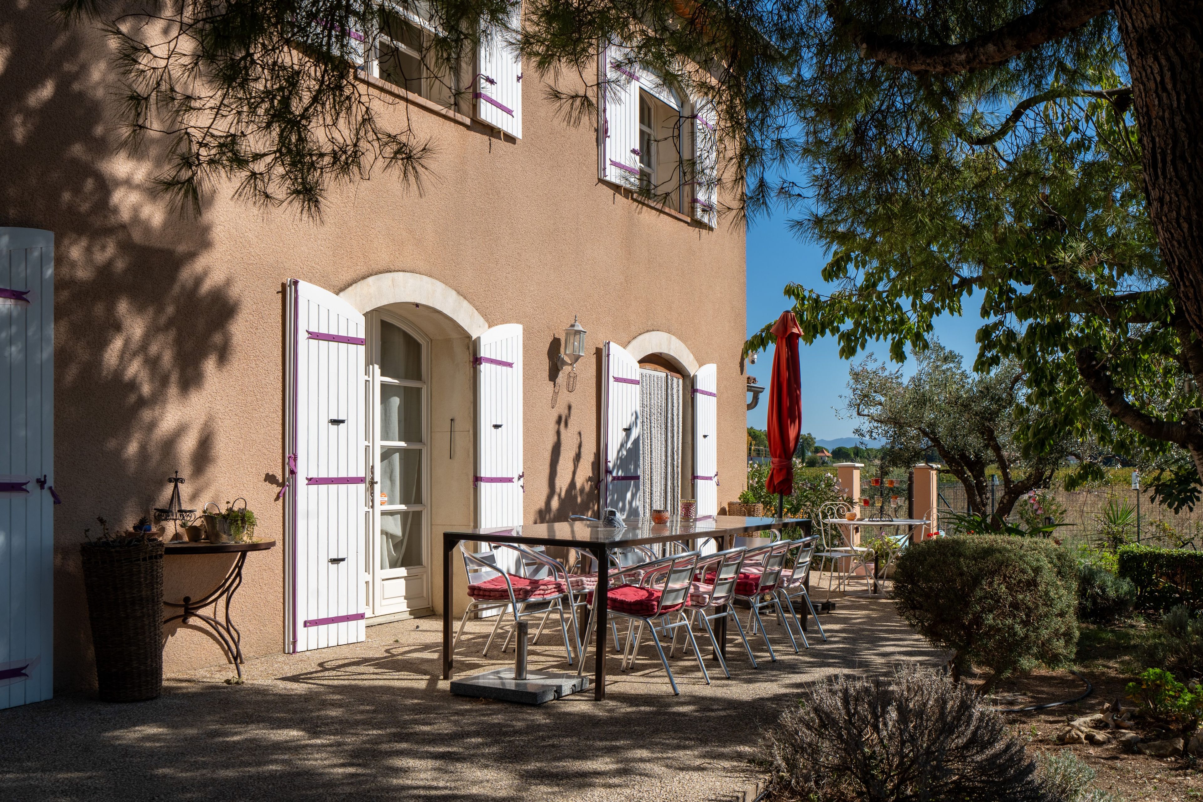 Un edificio con un patio amoblado, que cuenta con mesas y sillas al aire libre.