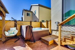 A hot tub, a hanging chair, and a wooden staircase in a backyard setting. - Park City Views! Hot Tub, Game Room & EV Charger (Park City)