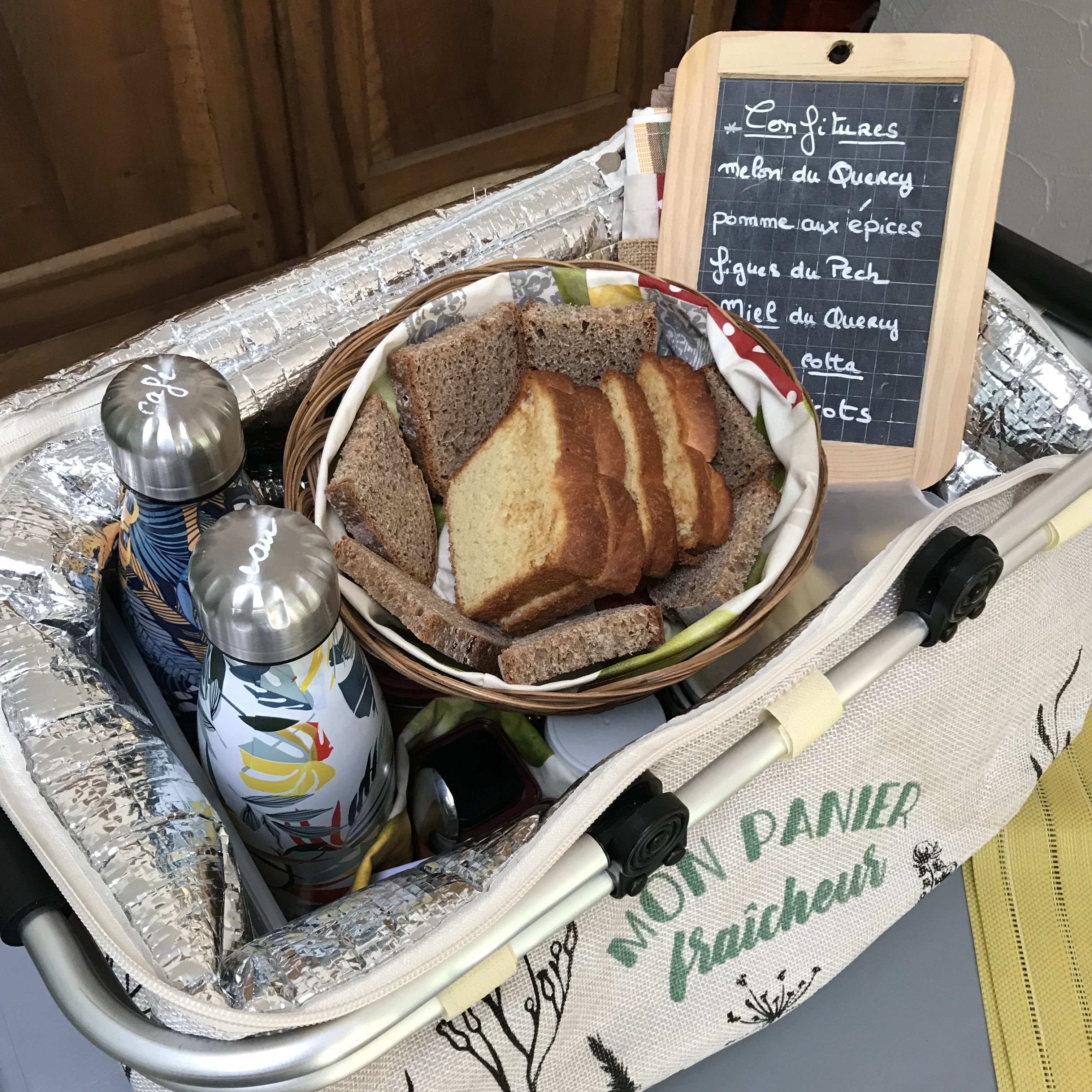 A kitchen trolley with bread, condiments, and a chalkboard menu.