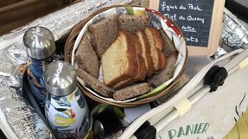 A kitchen trolley with bread, condiments, and a chalkboard menu.