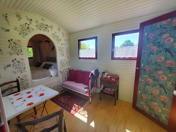 Una stanza accogliente con un letto, un tavolo e una finestra vista.