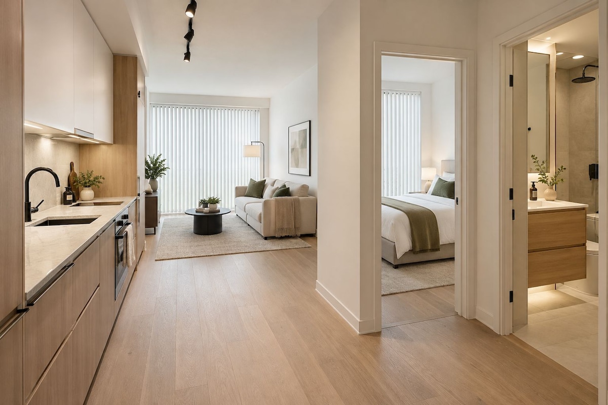 Un apartament modern amb cuina, sala d'estar i dormitori.