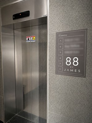 An elevator with a digital display showing the number 88 and the name 'James'.