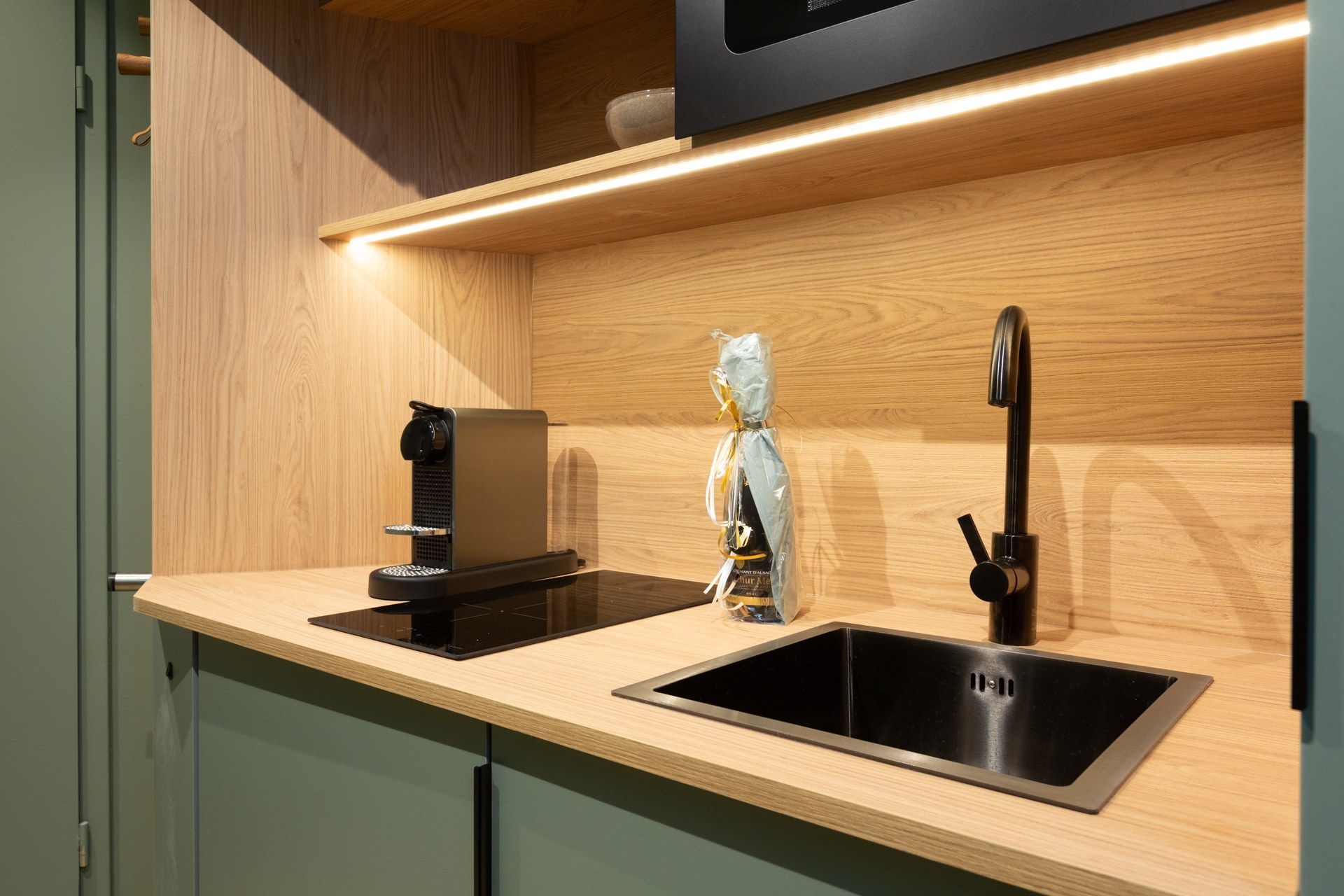 A modern kitchen with a built-in stove, a sink, and a wooden countertop.