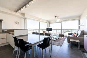 A modern apartment with a kitchen, dining area, and living space. - Apartment by Belgian Coast With Sea Views (Blankenberge)