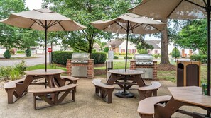 An outdoor patio with picnic tables and barbecue grills. - Williamsburg | Pool & Family Activities | 3BR Sleeps 10 (Williamsburg)