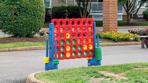 A playground with a red and blue climbing structure. - Williamsburg | Pool & Family Activities | 3BR Sleeps 10 (Williamsburg)