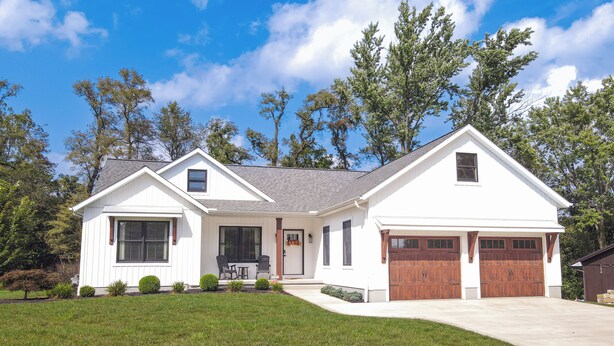 A single-story house with a front porch, a garage, and a well-maintained lawn. - Modern Farmhouse In Salem (Salem)