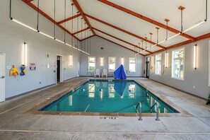 An indoor swimming pool with a high ceiling, built-in lighting, and a clear view of the pool area. - A View to Remember SkiinSkiout SugarSkiStudioCondo (Sugar Mountain)