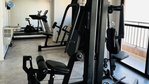 A gym with various exercise equipment including a treadmill, weight machines, and a bench. - New and Modern • Partridges • 800m Allianz Parque • (São Paulo)