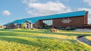 A recreation center with a modern design, featuring a prominent blue roof and brick exterior. - Pagosa Springs | Hot Tub & Mountains | 2BR Deluxe (Pagosa Springs)