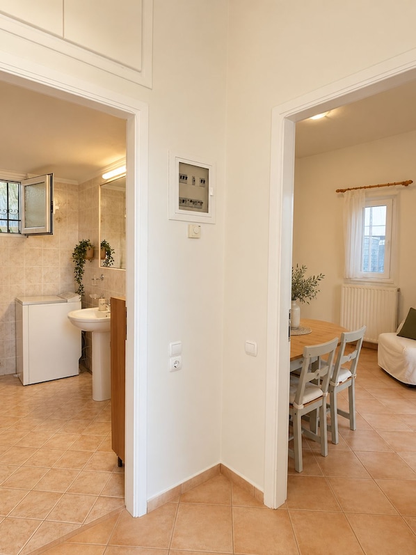 A clean, modern kitchen with white cabinets, a sink, and a window.