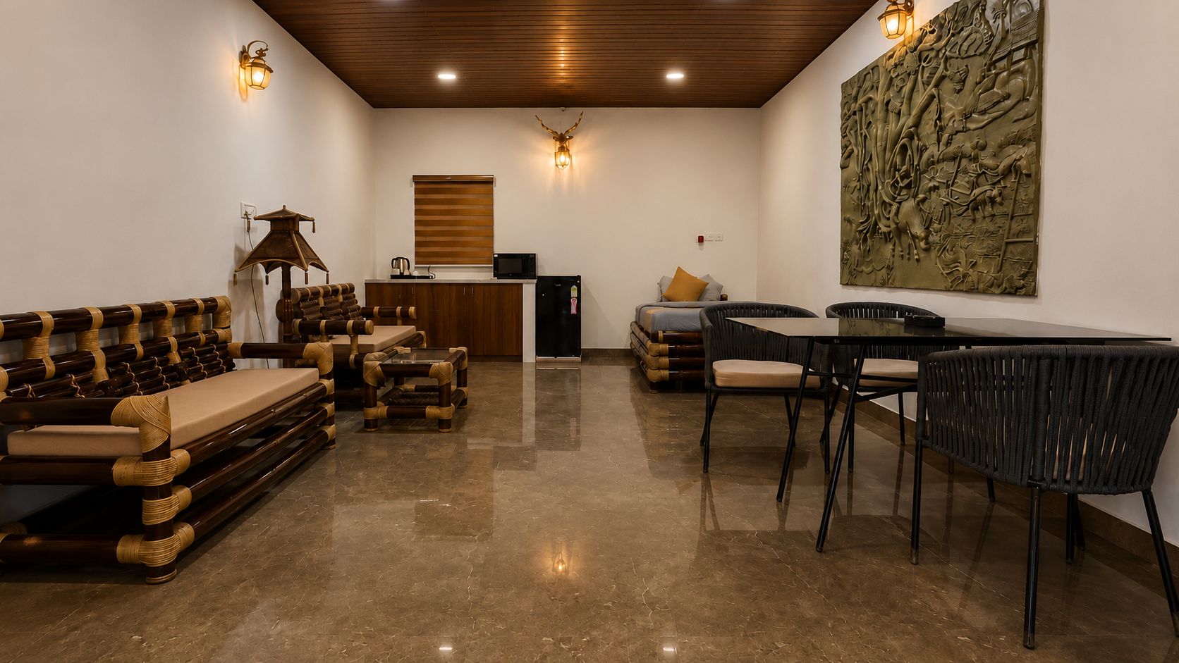 A spacious room with a wooden ceiling, a dining area with a table and chairs, a sofa set, and a wall-mounted sculpture.