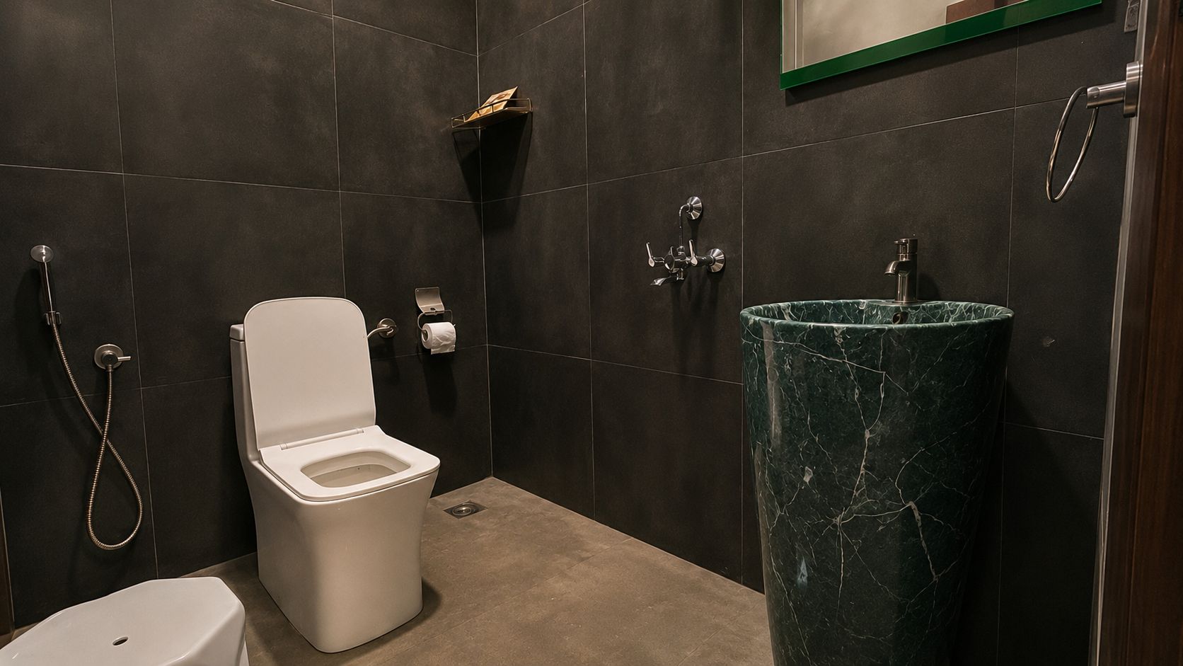 A modern bathroom with a toilet, a sink, and a shower.