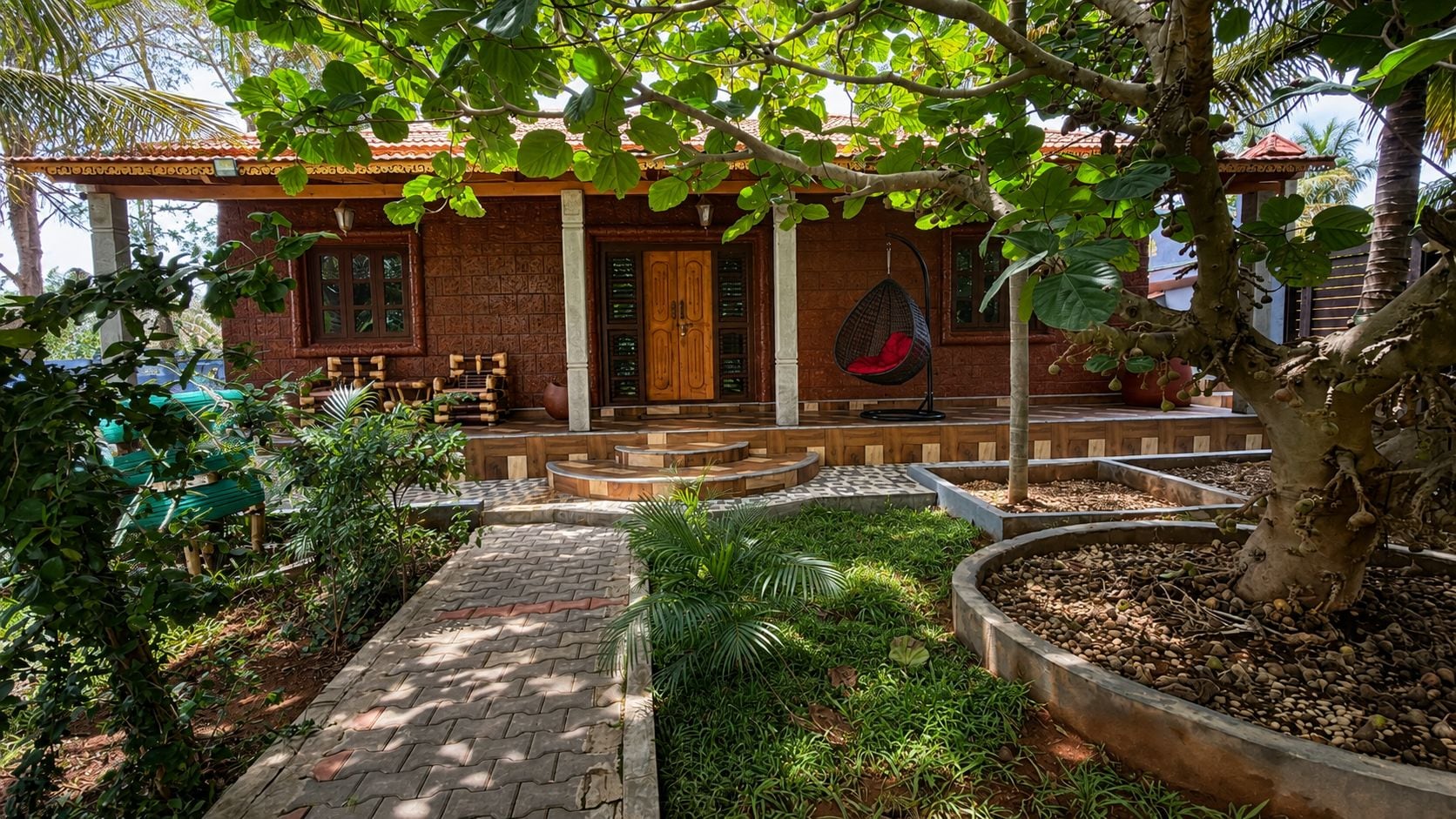 Uma casa com fachada de tijolos, varanda de madeira e uma cadeira suspensa.