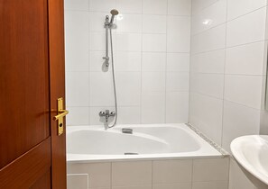 A bathroom with a bathtub, a shower, and a sink. - The Quiet Corner (Tunis)