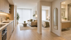 A modern interior with a kitchen, living area, and bedroom. - Unionmark Suites (Toronto)