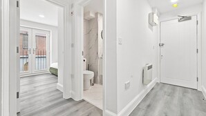 A modern bathroom with a toilet, sink, and shower.