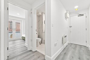 A modern bathroom with a toilet, sink, and shower.