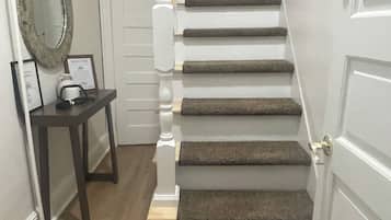 A staircase with wooden steps and a white door at the top.