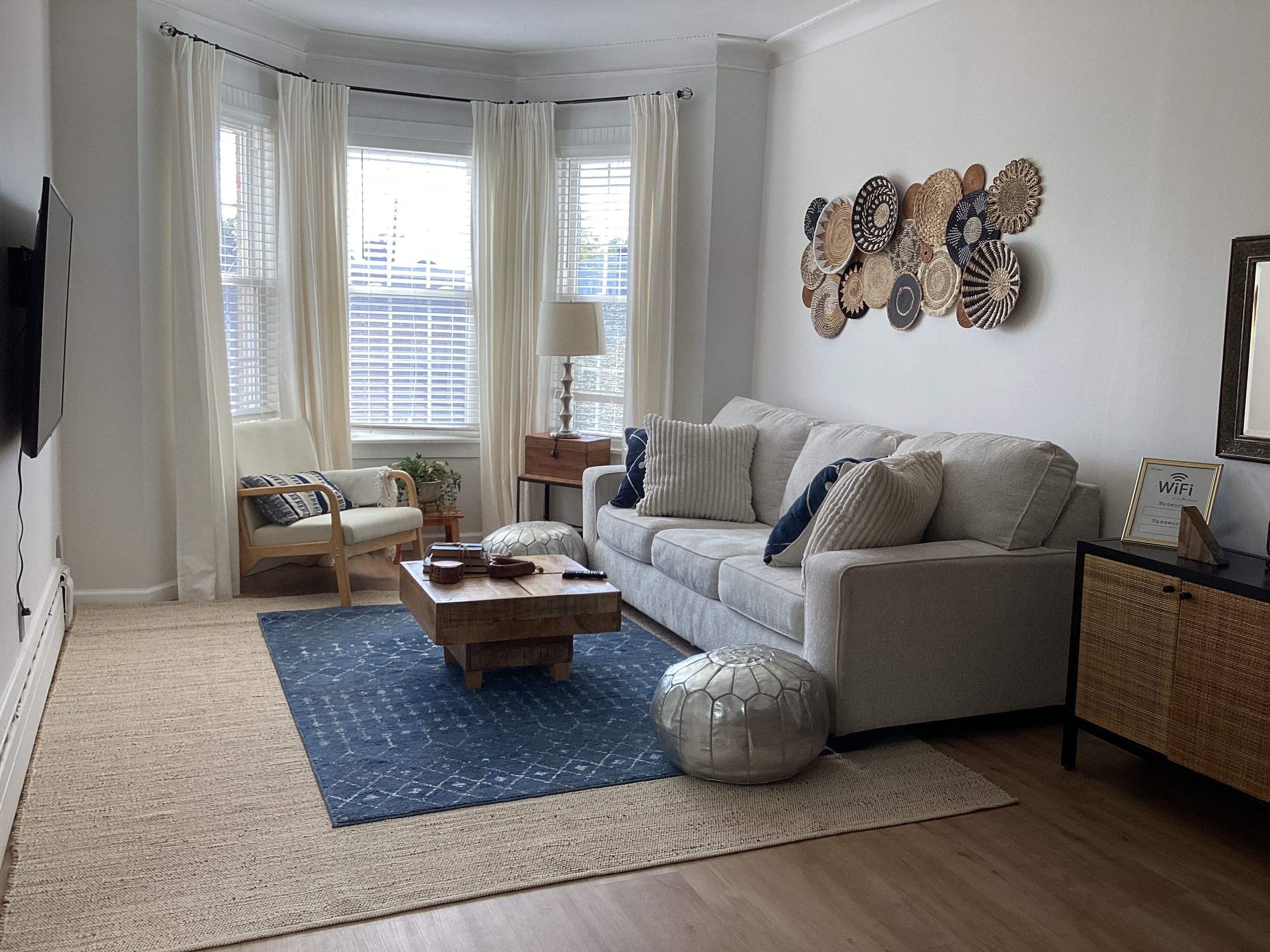 A living room with a sofa, coffee table, and decorative wall art.