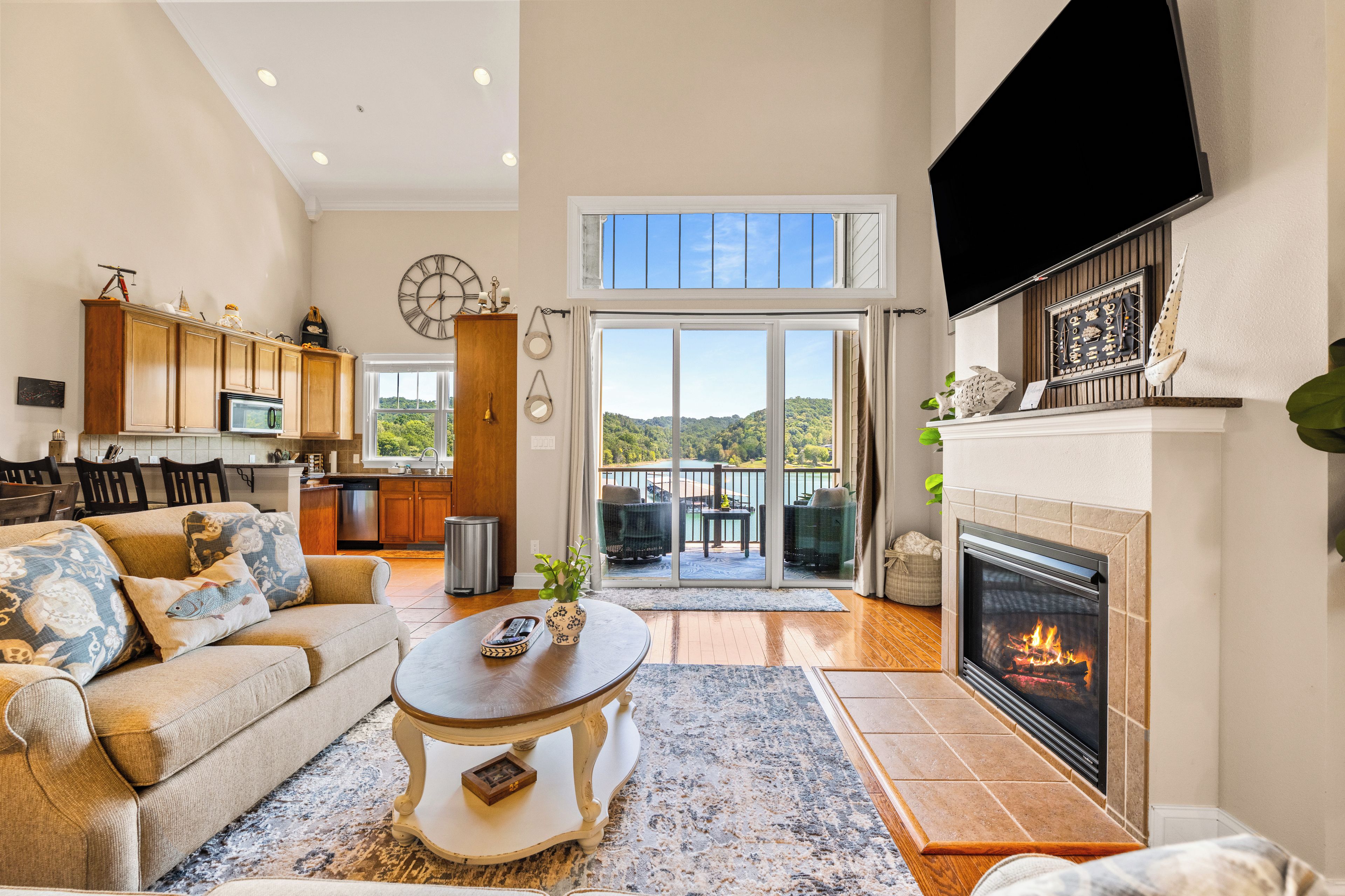 A spacious living area with a fireplace, a dining area, and a kitchen.