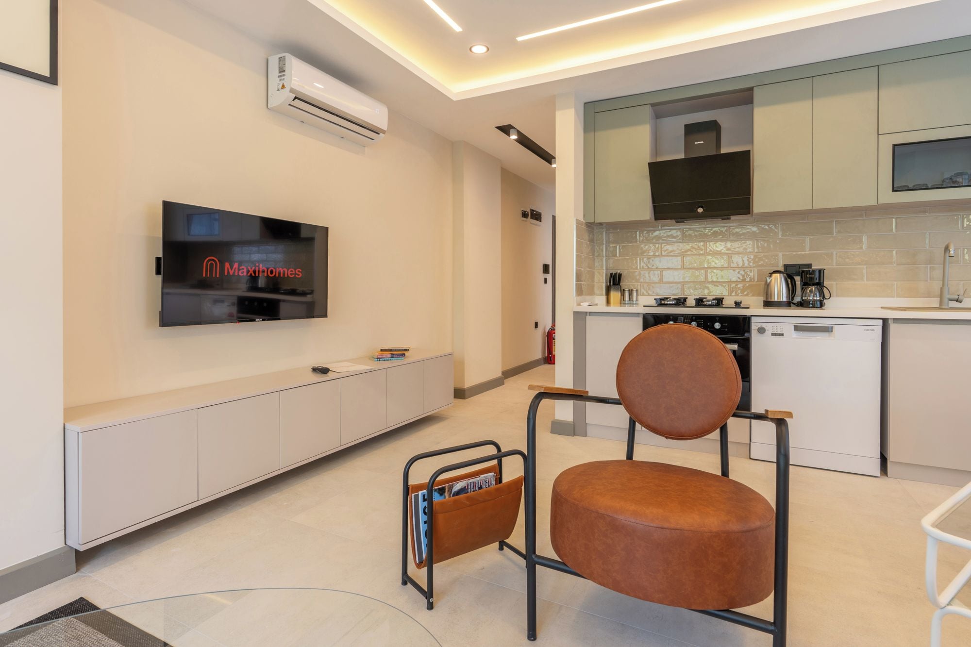 A modern living room with a flat-screen TV, a sofa, and a coffee table.