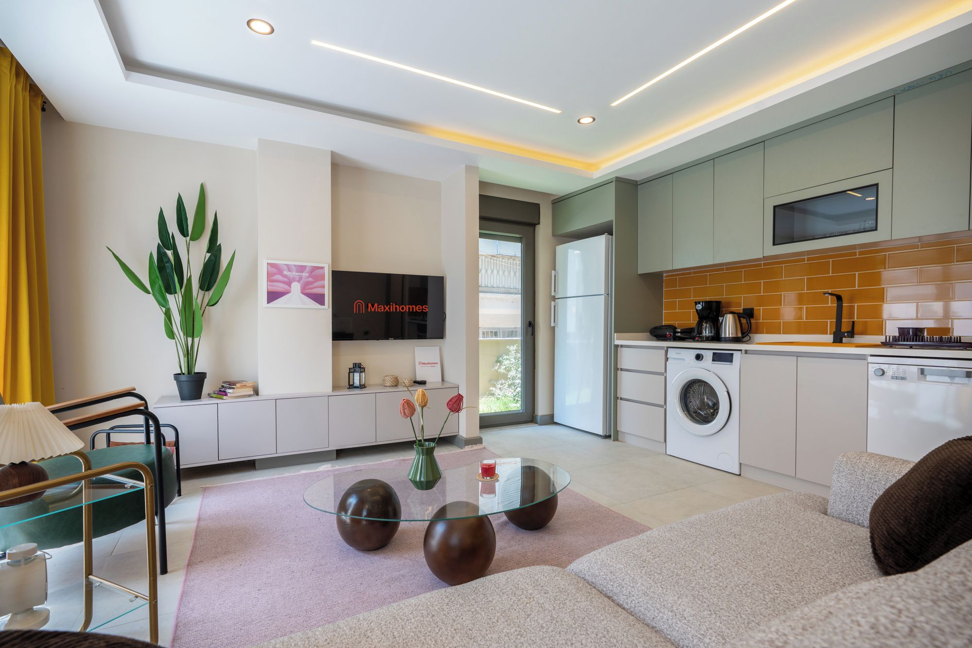 A modern living room with a glass coffee table, sofas, a TV, and a potted plant.