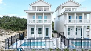 A two-story beachfront house with a swimming pool, a covered patio, and a fenced deck area. - NEW: Saltwater Sky - Rooftop deck and private pool (Eastpoint)