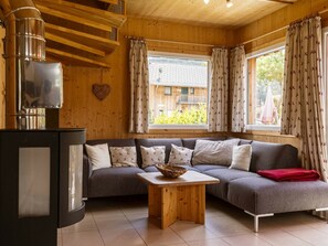 Ein gemütliches Wohnzimmer mit einer Couch, einem Holztisch und einem Kamin.