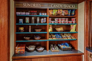 A snack and sundries display with various products like snacks, drinks, and household items. - Accessible 2BR Suite | Free Daily Breakfast + Pool (Glendale)