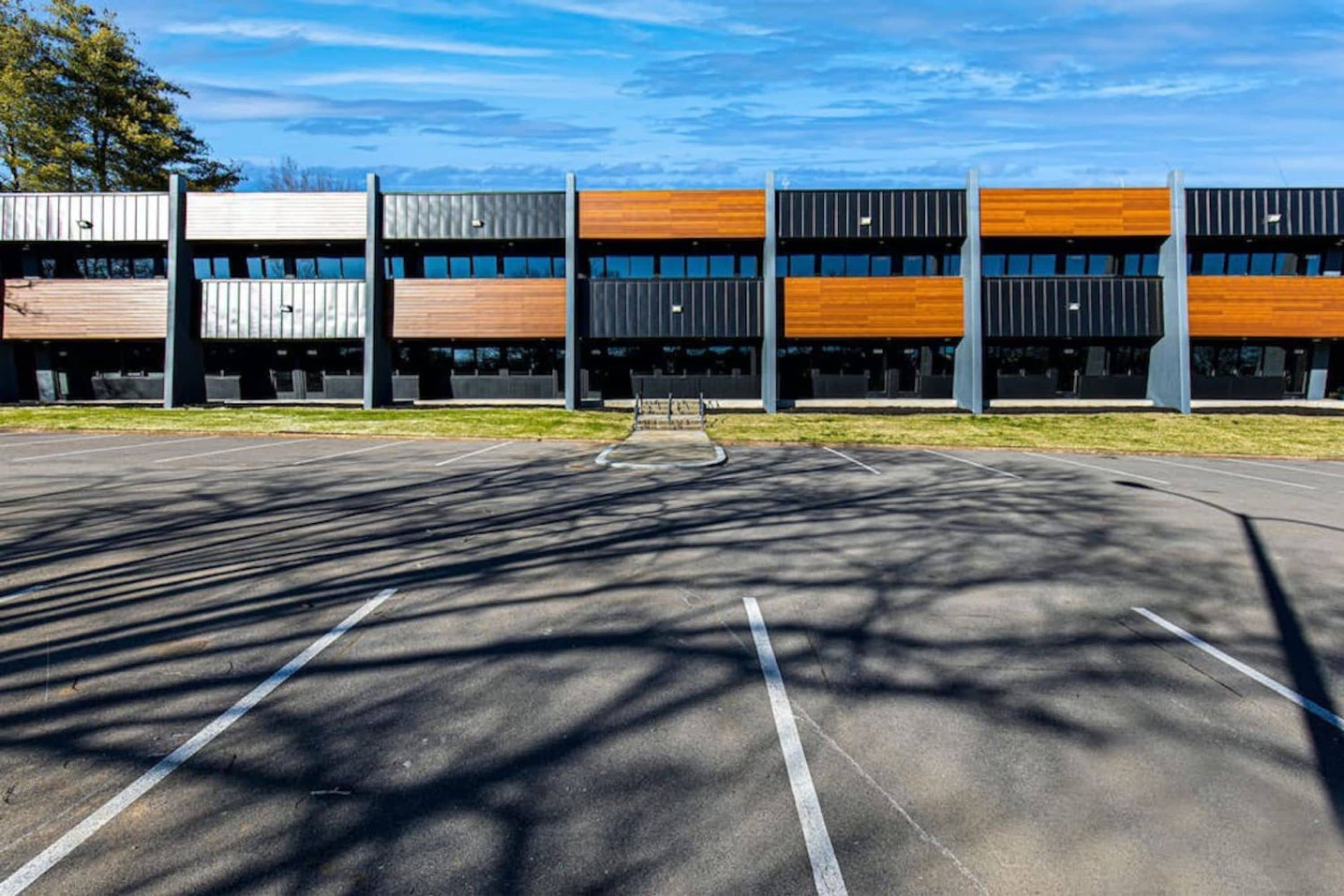 A parking lot with a building in the background.