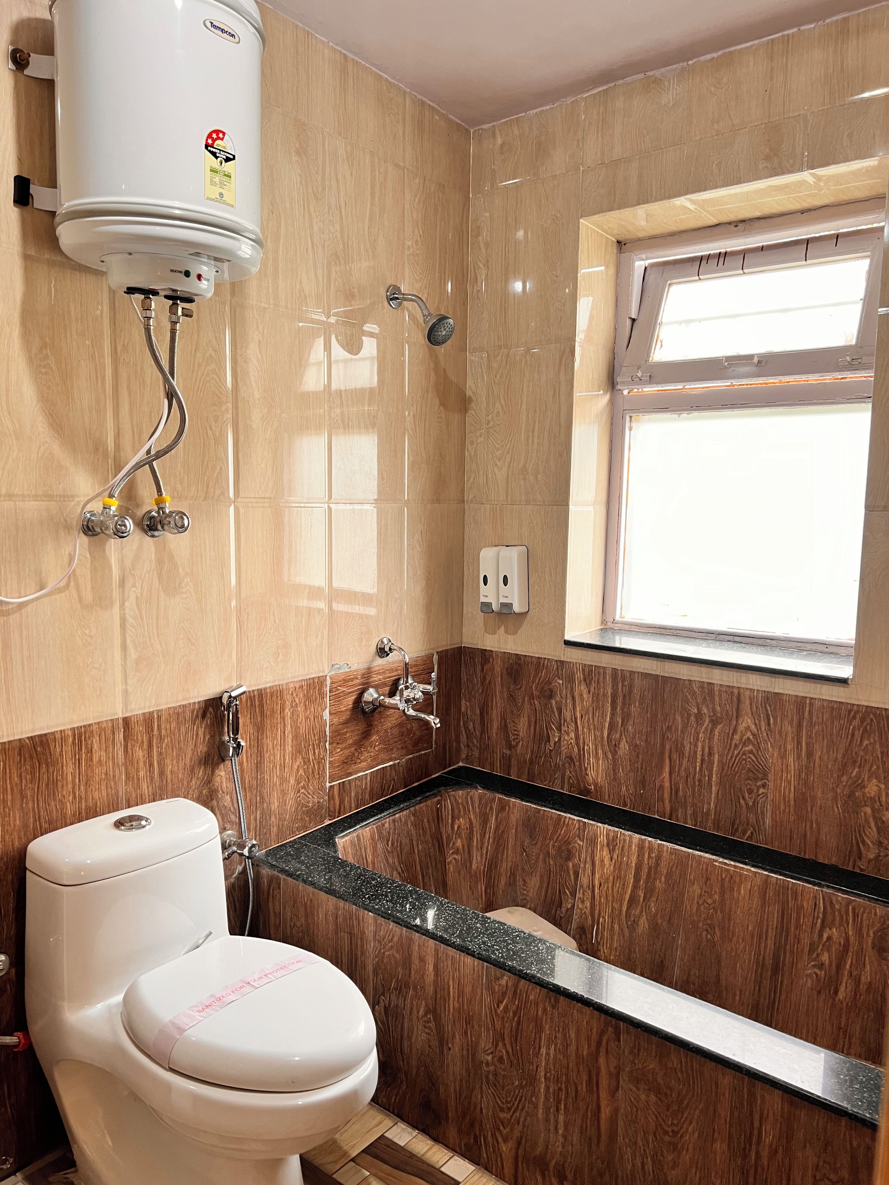 A bathroom with a toilet, a shower, and a bathtub.