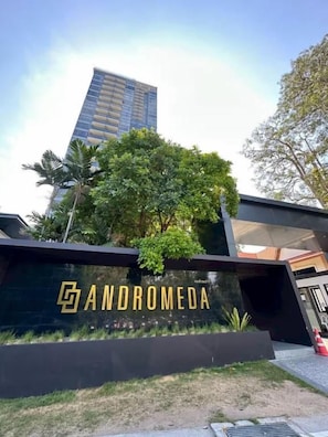 A modern building with a prominent sign reading 'ANDROMEDA' and a tall skyscraper in the background. - Andromeda Condominium Pattaya (Muang Pattaya)