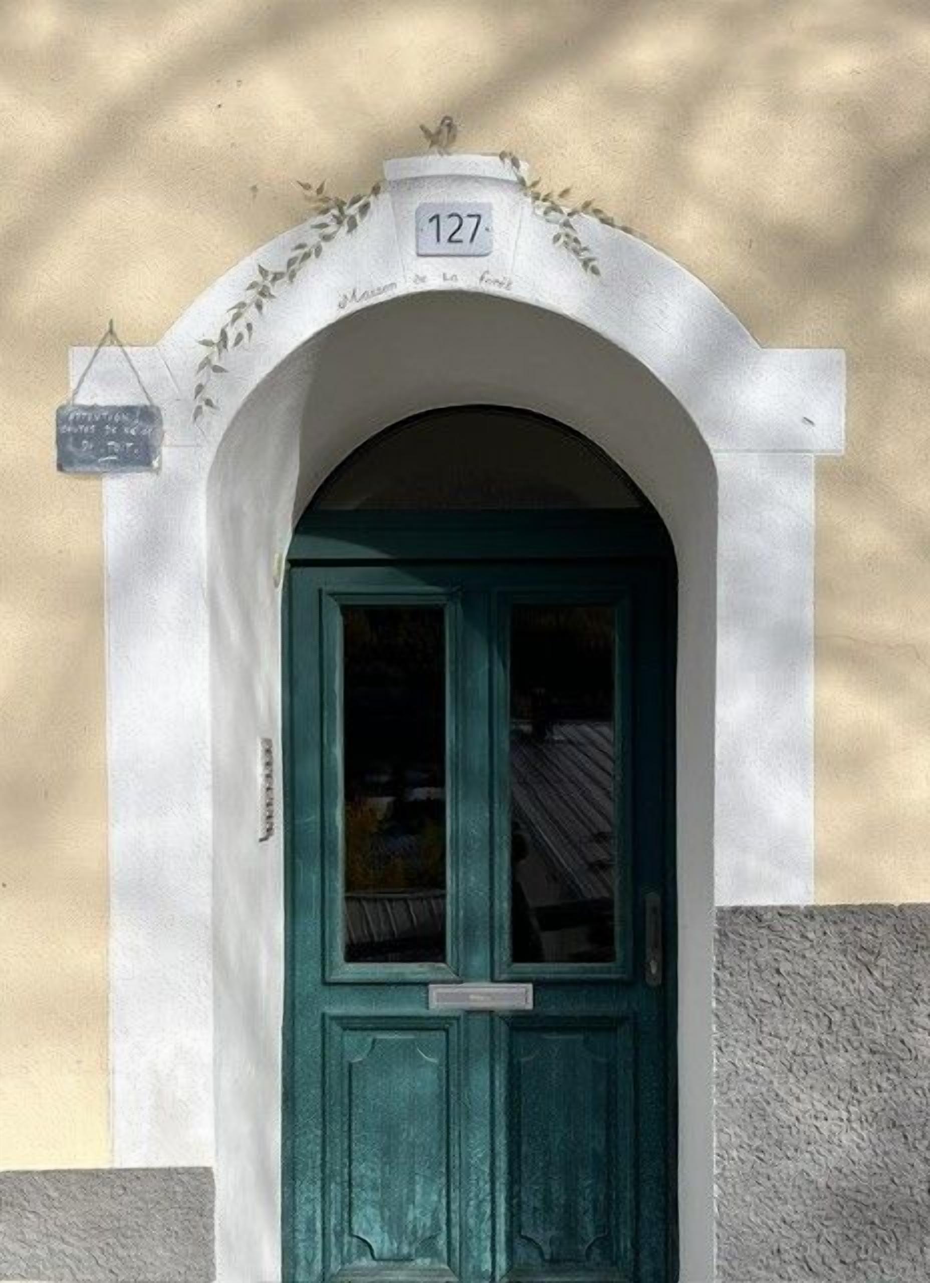 A door with a number sign above it, indicating a specific location.