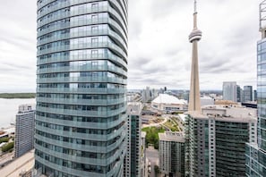 Un immeuble moderne de grande hauteur, doté d’une façade incurvée, d’une tour imposante et offrant une vue sur le front de mer.